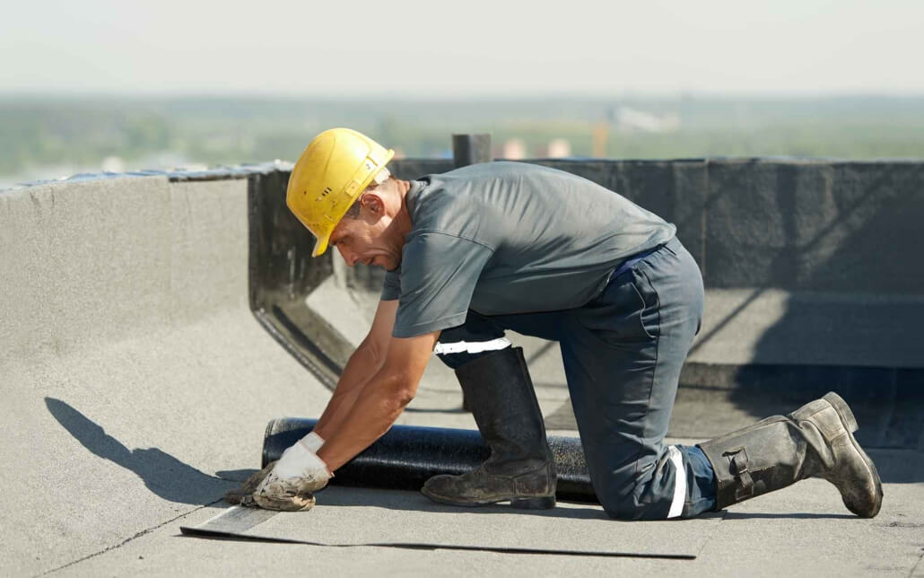 worker installing smaller sheet of shingle