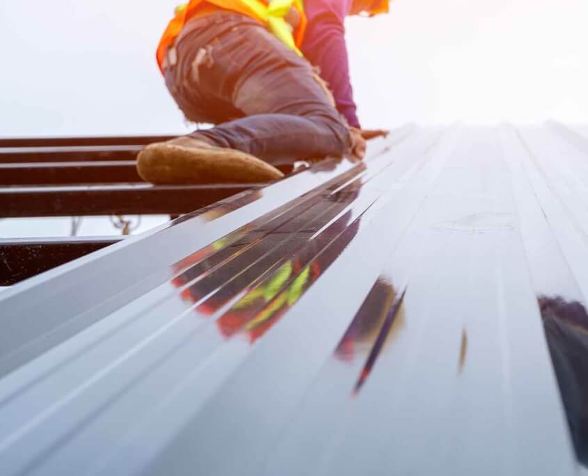 workers installing sheet metal roof vertical