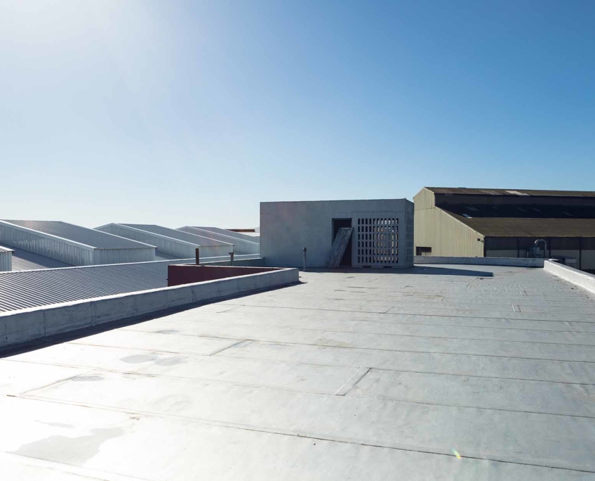 Top view of a white industrial warehouse roof