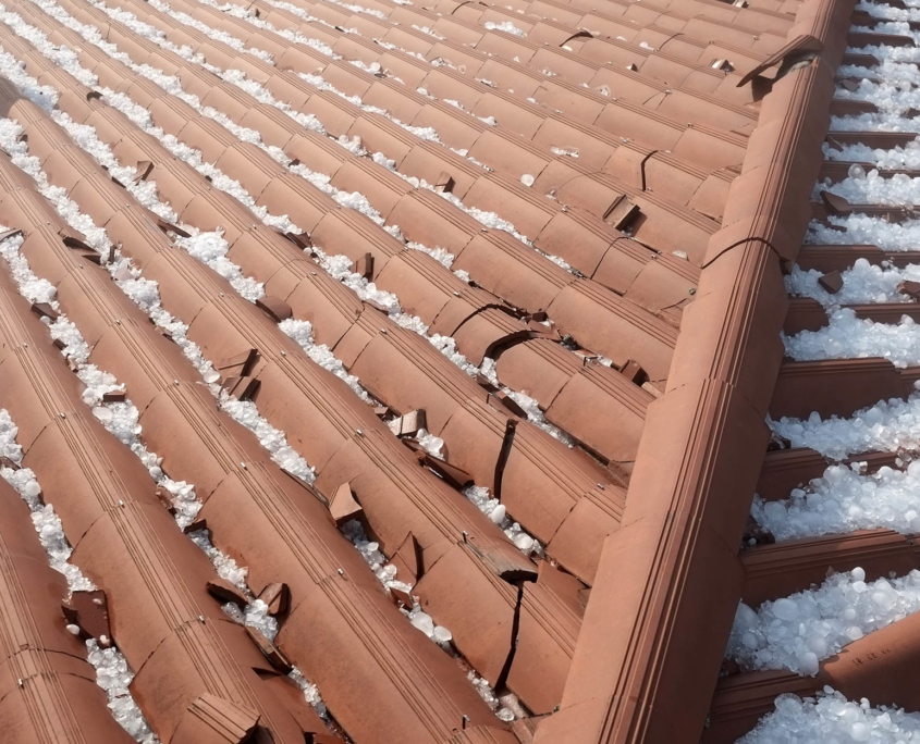Clay tile rooftop damage after hail storm