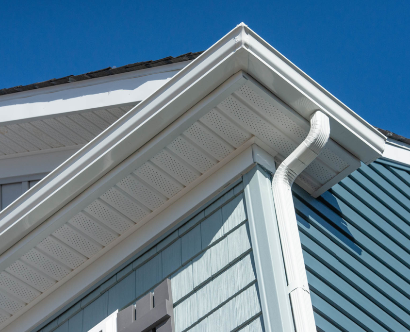 Residential gutters on the side of blue home