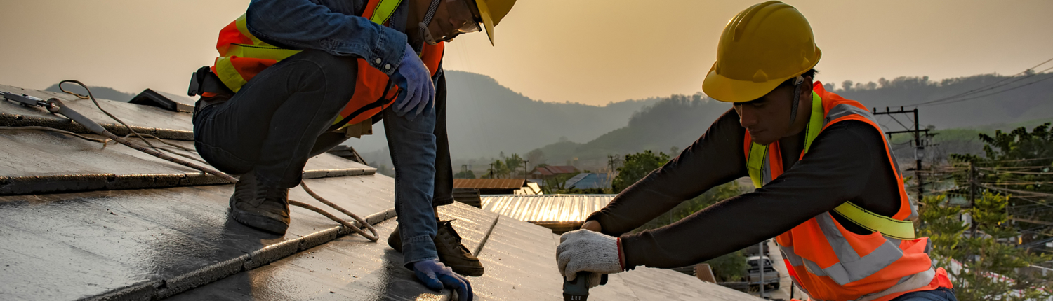 Two Construction Workers Installing Commercial Roofing