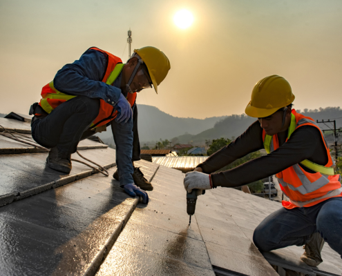 Two Construction Workers Installing Commercial Roofing