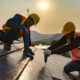 Two Construction Workers Installing Commercial Roofing