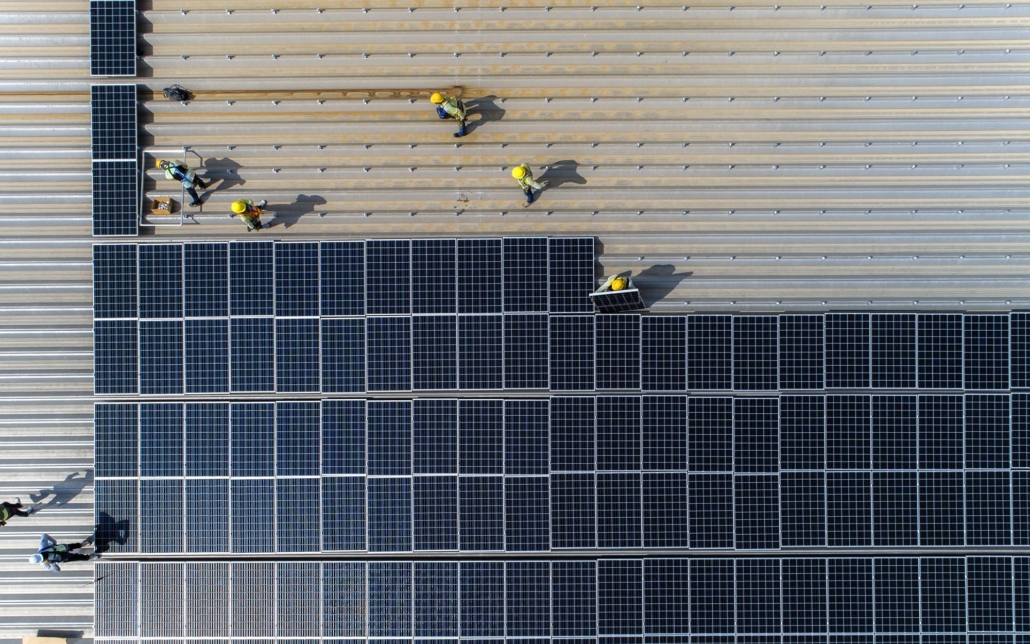 Overhead view of solar panels on a commercial roof