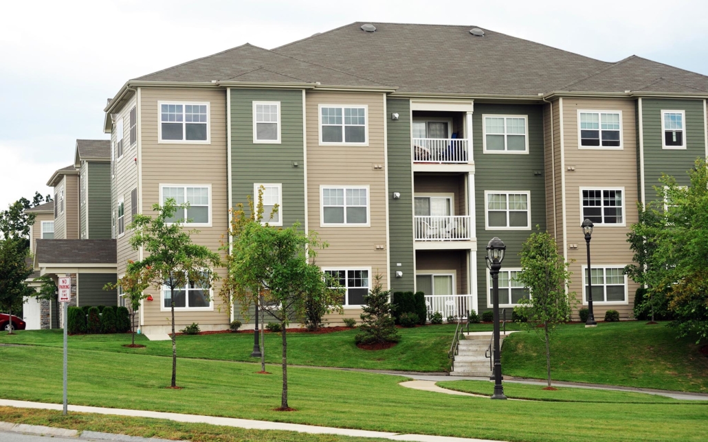 Side view of green and brown apartments