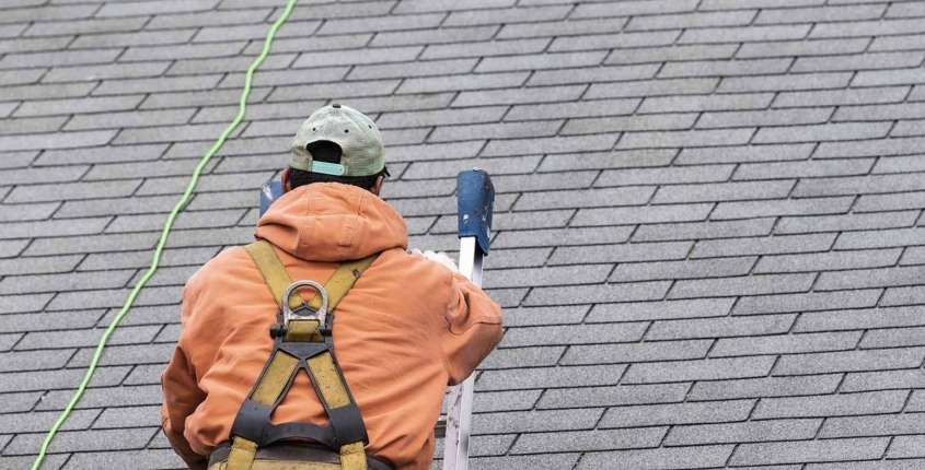 person inspecting roof